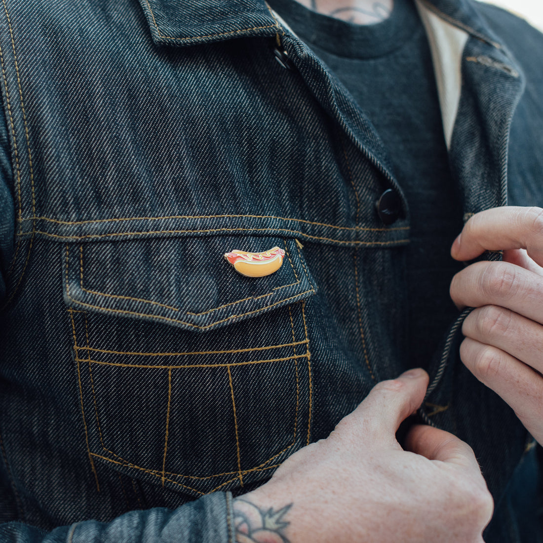 Man buttoning a rugged vintage workwear jacket